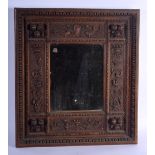 AN ANTIQUE EUROPEAN CARVED WOOD MIRROR decorated with scrolling birds and foliage. 45 cm square.