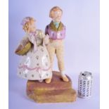 A VINTAGE AUSTRIAN PORCELAIN FIGURE OF A BOY AND GIRL modelled upon a stepped base. 42 cm x 20 cm.