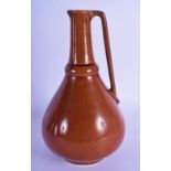 AN UNUSUAL ARTS AND CRAFTS BROWN GLAZED POTTERY EWER in the manner of Dr Christopher Dresser. 24 cm