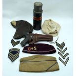 A group of American military hats together with a replica luger pistol and holster and a vintage The