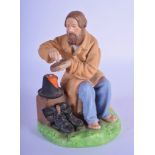 A 19TH CENTURY RUSSIAN GARDNER PORCELAIN FIGURE OF A PEASANT modelled sprinkling salt upon bread. 14