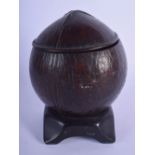 A GEORGE III CARVED COCONUT TEA CADDY upon a hardwood base. 16 cm x 8 cm.