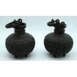 A pair of Indian Bronze Incense burners heavily embossed with Peacocks and foliage. 15cm (2).