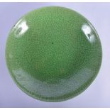 A 19TH CENTURY CHINESE GREEN CRACKLE GLAZED MONOCHROME DISH Qing, of plain form. 19 cm diameter.