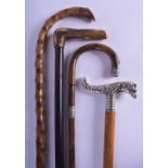AN UNUSUAL ANTIQUE SILVER MOUNTED WALKING CANE together with two bamboo canes & another. (4)
