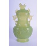 AN EARLY 20TH CENTURY CHINESE TWIN HANDLED JADE VASE AND COVER Late Qing, decorated with taotie mask