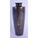 A 19TH CENTURY JAPANESE MEIJI PERIOD BRONZE TAPERING VASE inlaid with flowers and flowering bamboo.