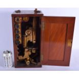 AN ANTIQUE BOXED SCIENTIFIC MICROSCOPE with various lenses. 39 cm high