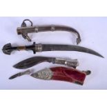 TWO ANTIQUE MIDDLE EASTERN WHITE METAL OVERLAID DAGGERS with embossed sheath. Largest 40 cm long. (2