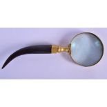 A 19TH CENTURY CONTINENTAL CARVED RHINOCEROS HORN HANDLED MAGNIFYING GLASS with curving handle. 21 c