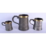 THREE 18TH CENTURY PEWTER MEASURES. Largest 16.5 cm high. (3)