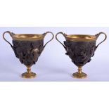 A RARE PAIR OF 19TH CENTURY ELKINGTON PEDESTAL BRONZE VASES After the Antique, decorated with figure