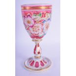 A 19TH CENTURY BOHEMIAN CRANBERRY GLASS CUP enamelled with foliage and vines. 19 cm high.