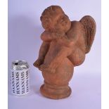 A MID 20TH CENTURY FRENCH TERRACOTTA FIGURE OF A PUTTI modelled upon a stepped base. 32 cm x 15 cm.