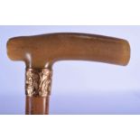 A 19TH CENTURY MIDDLE EASTERN CARVED RHINOCEROS HORN HANDLED WALKING CANE. 86 cm long.