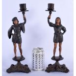 A PAIR OF 19TH CENTURY CAST IRON COLD PAINTED CANDLESTICKS modelled upon shaped base. 35 cm high.