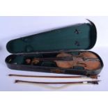 A CASED VIOLIN with two bows. (3)