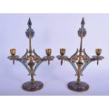 A PAIR OF 19TH CENTURY FRENCH CHAMPLEVE ENAMEL TWIN BRANCH CANDLESTICKS decorated with foliage and b