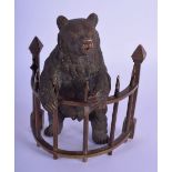 A RARE EARLY 20TH CENTURY AUSTRIAN BRONZE INKWELL modelled as a bear upon a fence. 13 cm x 8 cm.