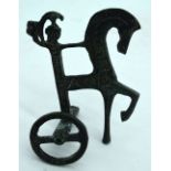 An Egyptian bronze stylised chariot rider. 10.5 x 8cm