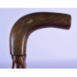 A 19TH CENTURY MIDDLE EASTERN CARVED RHINOCEROS HORN HANDLED WALKING CANE. 86 cm long.