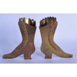 A PAIR OF ANTIQUE BRASS SHOE STANDS possibly candle or tinder holders. 20 cm x 15 cm.