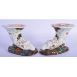 AN UNUSUAL PAIR OF EARLY 19TH CENTURY FRENCH PARIS PORCELAIN INKWELLS formed as stylised rams heads.