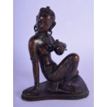 A 19TH CENTURY SOUTH EAST ASIAN INDIAN BRONZE BUDDHISTIC DEITY modelled upon a shaped base. 15 cm x