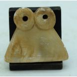 A carved stone figure of an Egyptian Idol on a stand 5.5 x 6 cm.