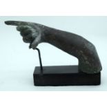 A Greco roman small bronze arm, possible a fragment, on a stand. 8 x 15cm