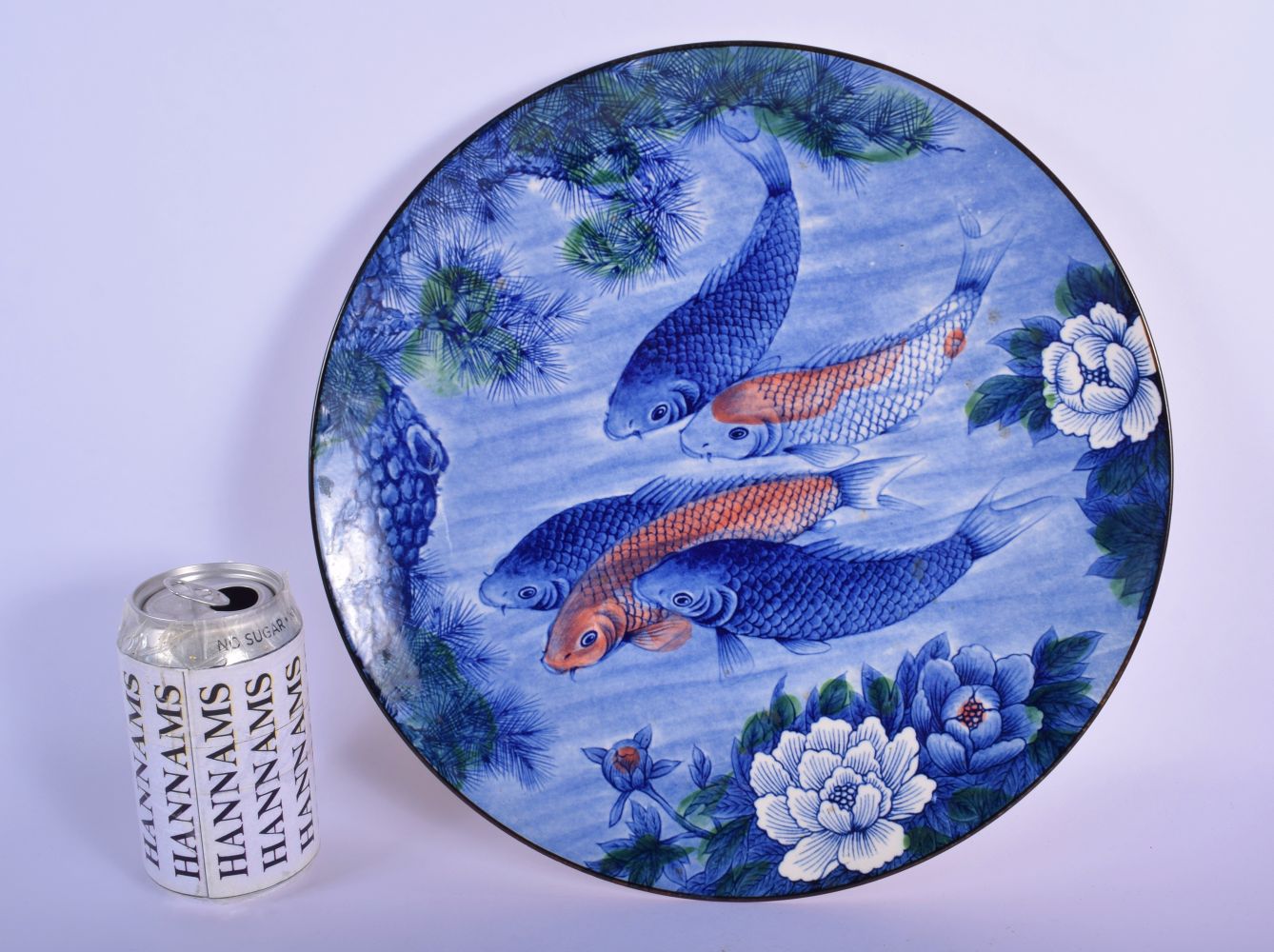 A JAPANESE TAISHO PERIOD PORCELAIN BLUE AND WHITE DISH decorated with swimming carp. 30 cm diameter.