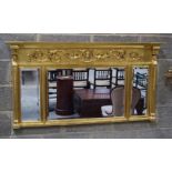 A LARGE REGENCY STYLE GILTWOOD MIRROR decorated with mask heads and foliage. 140 cm x 74 cm.