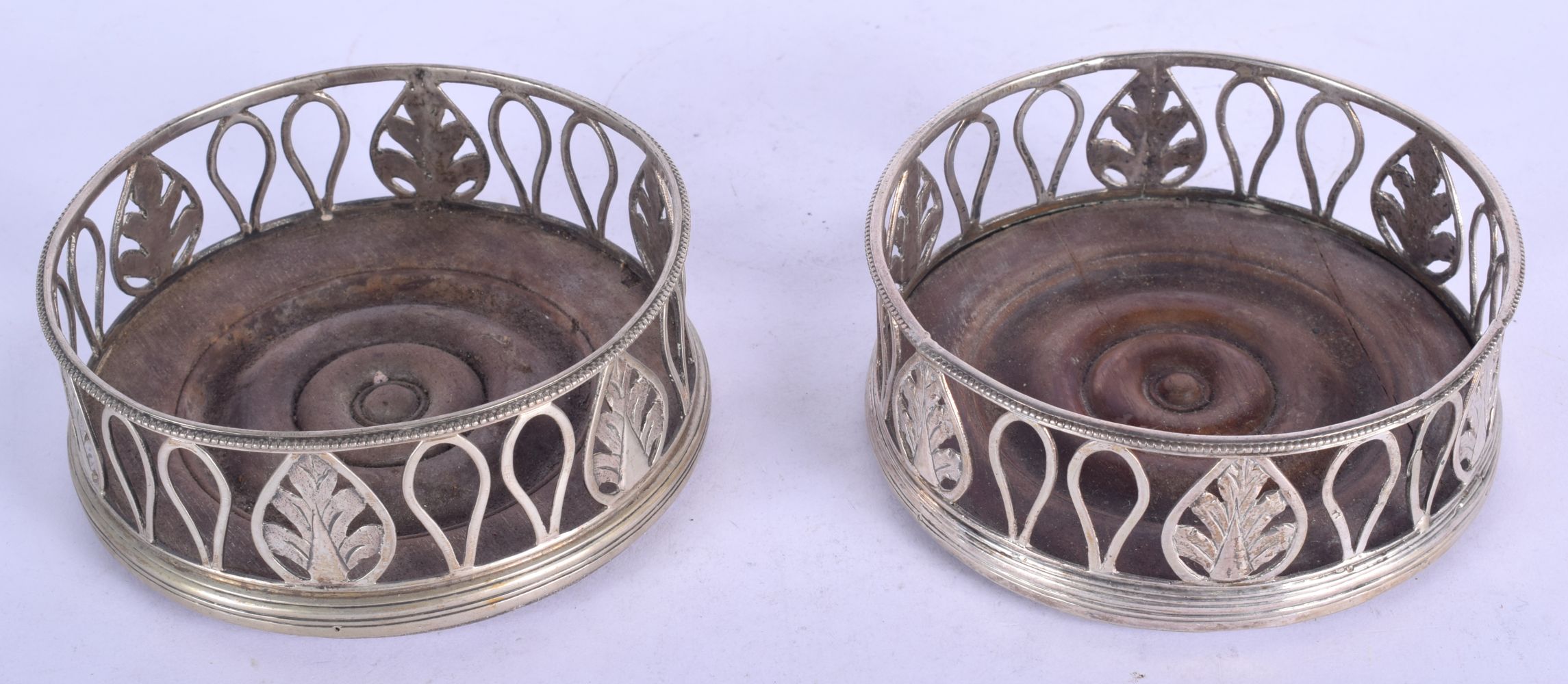 A PAIR OF ANTIQUE CONTINENTAL SILVER COASTERS. 12 cm diameter.