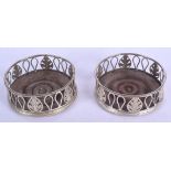 A PAIR OF ANTIQUE CONTINENTAL SILVER COASTERS. 12 cm diameter.