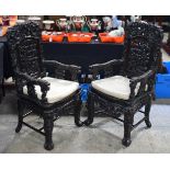 A PAIR OF 19TH CENTURY CHINESE HARDWOOD DRAGON ARM CHAIRS Qing, carved with figures and dragons amon