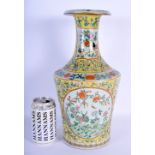 A 19TH CENTURY CHINESE FAMILLE JAUNE VASE decorated with floral patterns within panels. 34cm high.