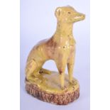 AN 18TH CENTURY CONTINENTAL YELLOW GLAZED SLIP HOUND modelled upon a ridged base. 13 cm x 8 c