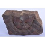AN EARLY CARVED STONE GROTESQUE MASK HEAD. 30 cm x 22 cm.