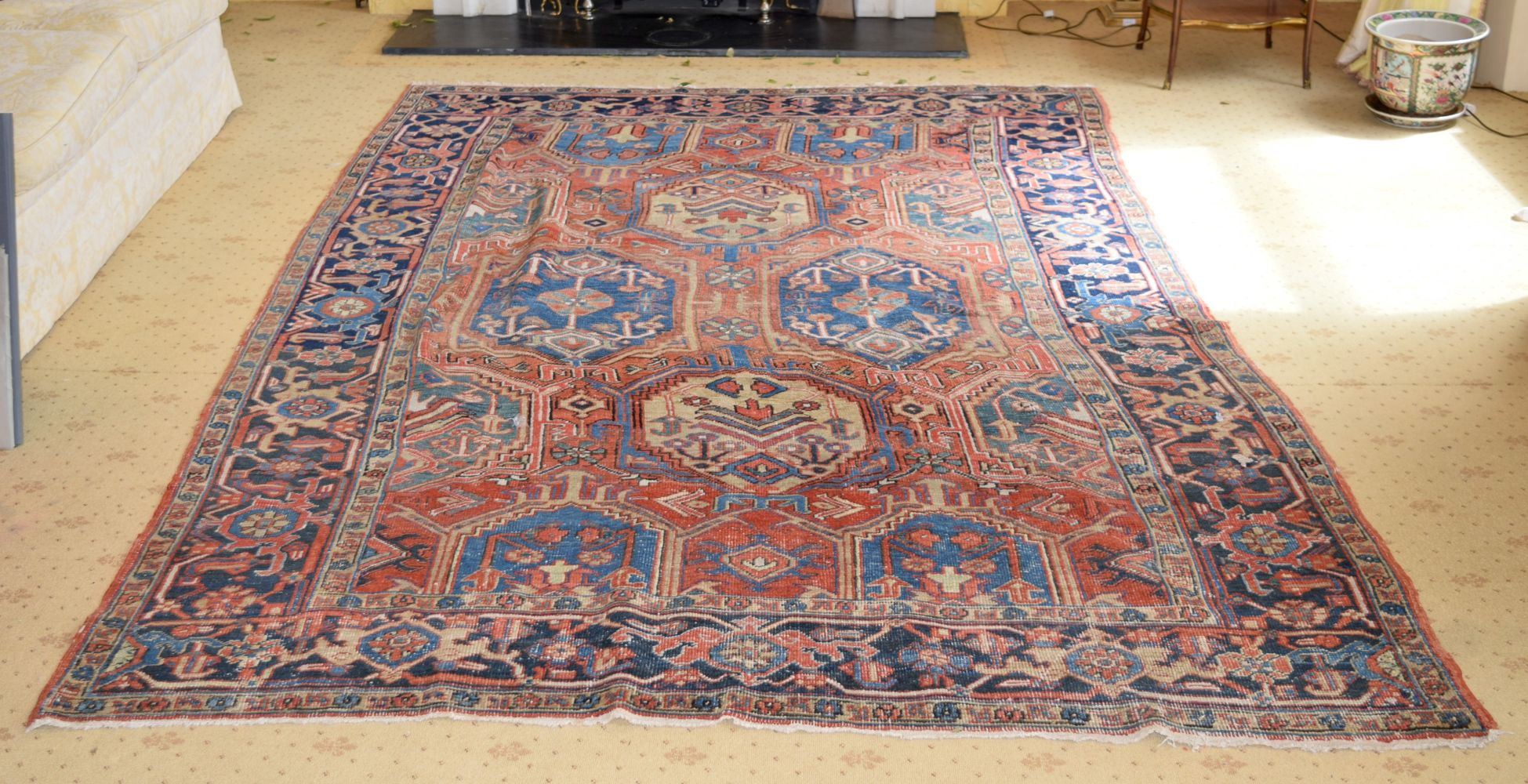 AN ANTIQUE MIDDLE EASTERN CARPET decorated with motifs on a red and blue ground. 300 cm x 195 cm.