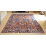 AN ANTIQUE MIDDLE EASTERN CARPET decorated with motifs on a red and blue ground. 300 cm x 195 cm.