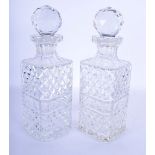 A PAIR OF CRYSTAL GLASS DECANTERS AND STOPPERS. 28 cm high.