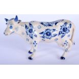 AN 18TH/19TH CENTURY DELFT BLUE AND WHITE PORCELAIN COW painted with flowers. 17 cm x 11 cm.