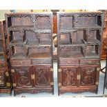 A LARGE PAIR OF EARLY 20TH CENTURY CHINESE CARVED HARDWOOD DISPLAY CABINETS decorated with elephants