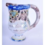 A FRENCH FAIENCE TIN GLAZED PUZZLE JUG. 17 cm high.