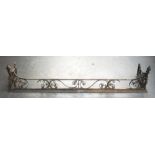 AN ANTIQUE WROUGHT IRON FIRESIDE FENDER. 146 cm x 33 cm.