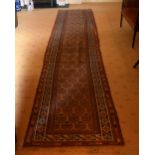 A LONG ANTIQUE PERSIAN RUNNER. 456 cm x 90 cm.