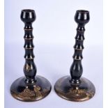 A PAIR OF REGENCY BLACK LACQUERED WOOD COUNTRY HOUSE CANDLESTICKS painted with Chinoserie scenes. 21