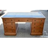 AN ANTIQUE LEATHER INSET PARTNERS DESK with drawers to both sides. 155 cm x 72 cm x 80 cm.