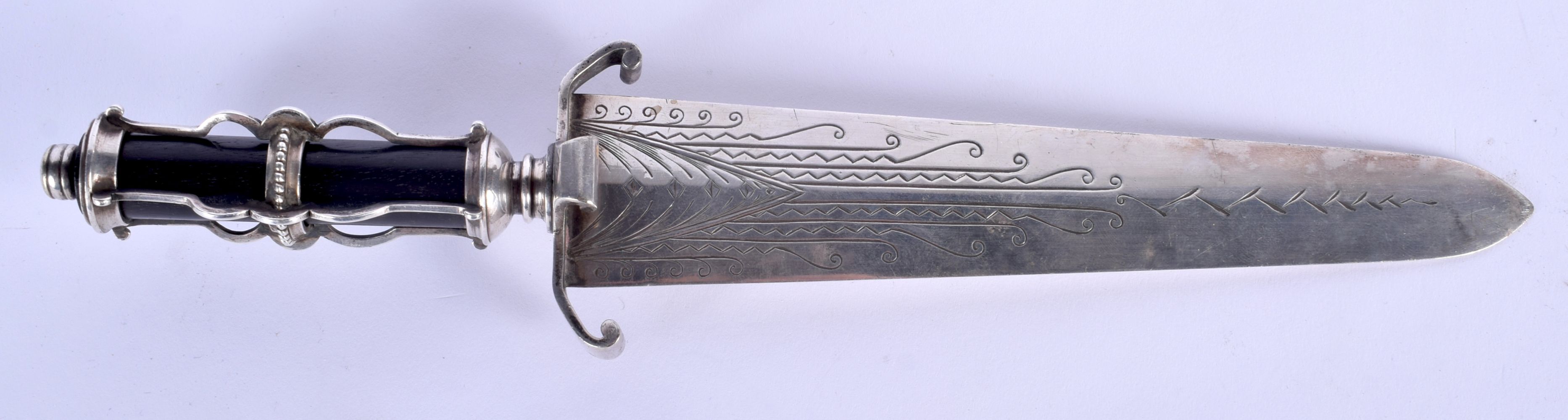 AN UNUSUAL EARLY 20TH CENTURY CONTINENTAL WHITE METAL DAGGER possibly silver, with ebonised handle. - Image 2 of 3