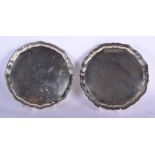 A MATCHED PAIR OF SILVER SALVERS. Sheffield 1911 & 1965. 1134 grams. 25 cm wide.